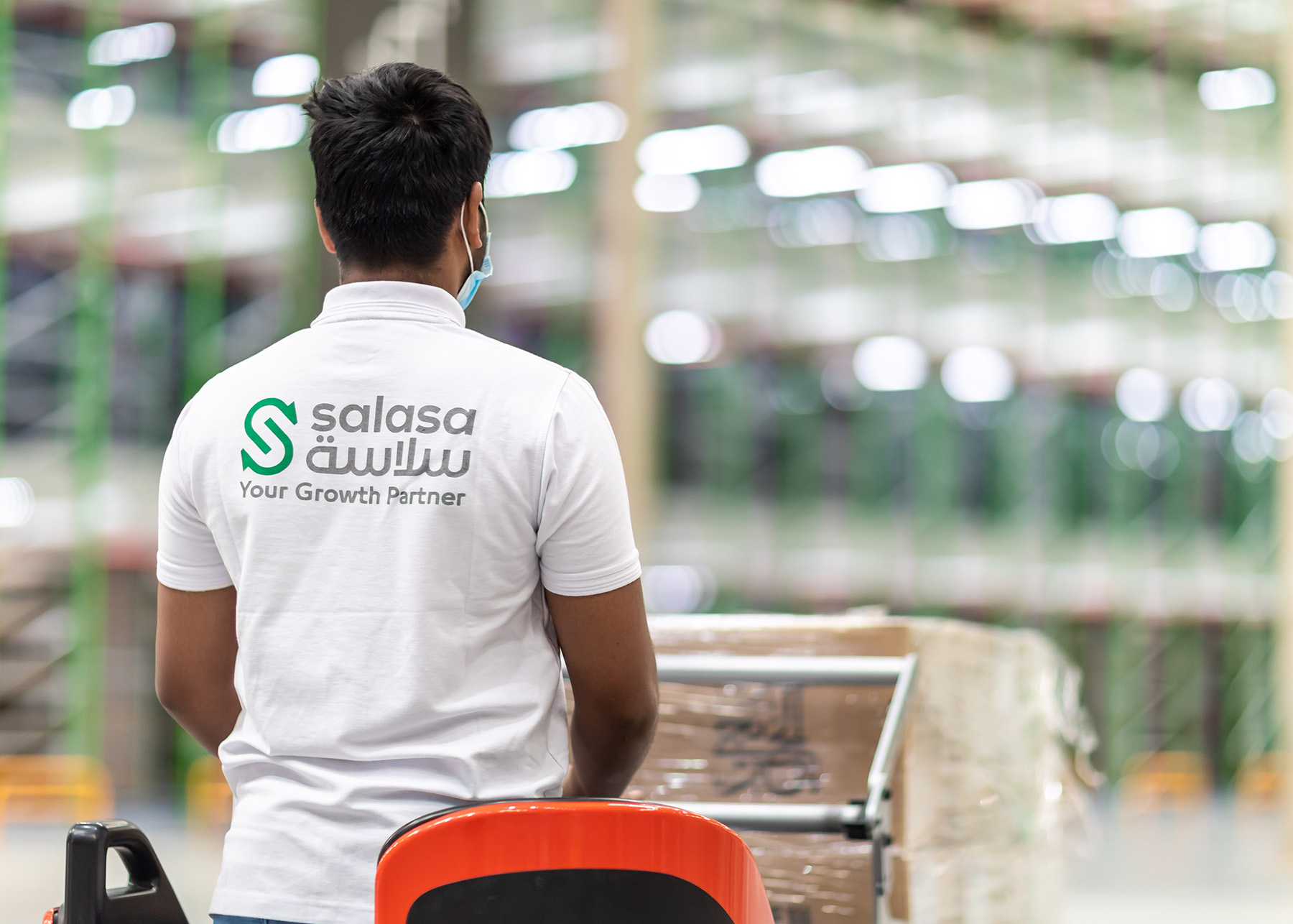 An employee wearing a Salasa shirt standing in a warehouse