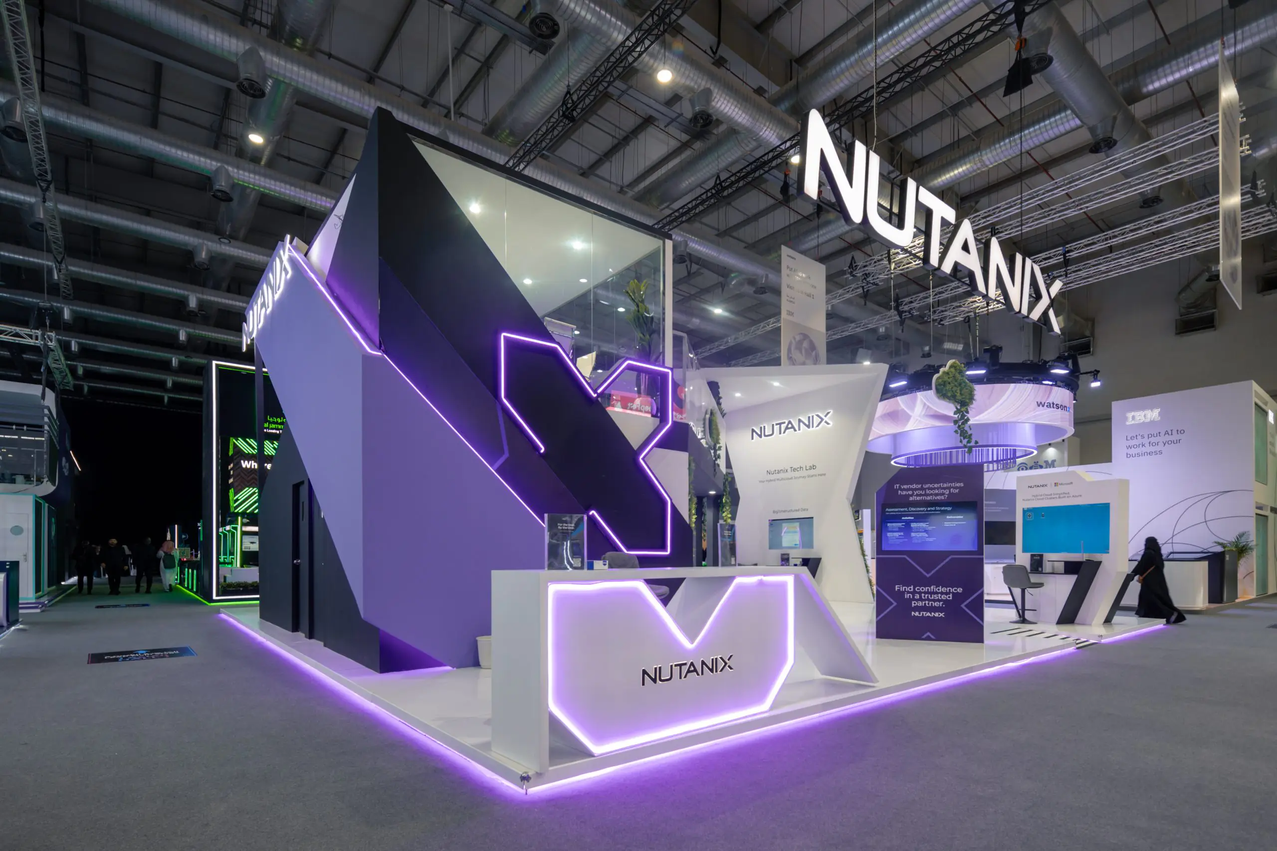 Nutanix booth at the Leap event featuring futuristic design with purple LED lighting, a tech lab, and interactive displays