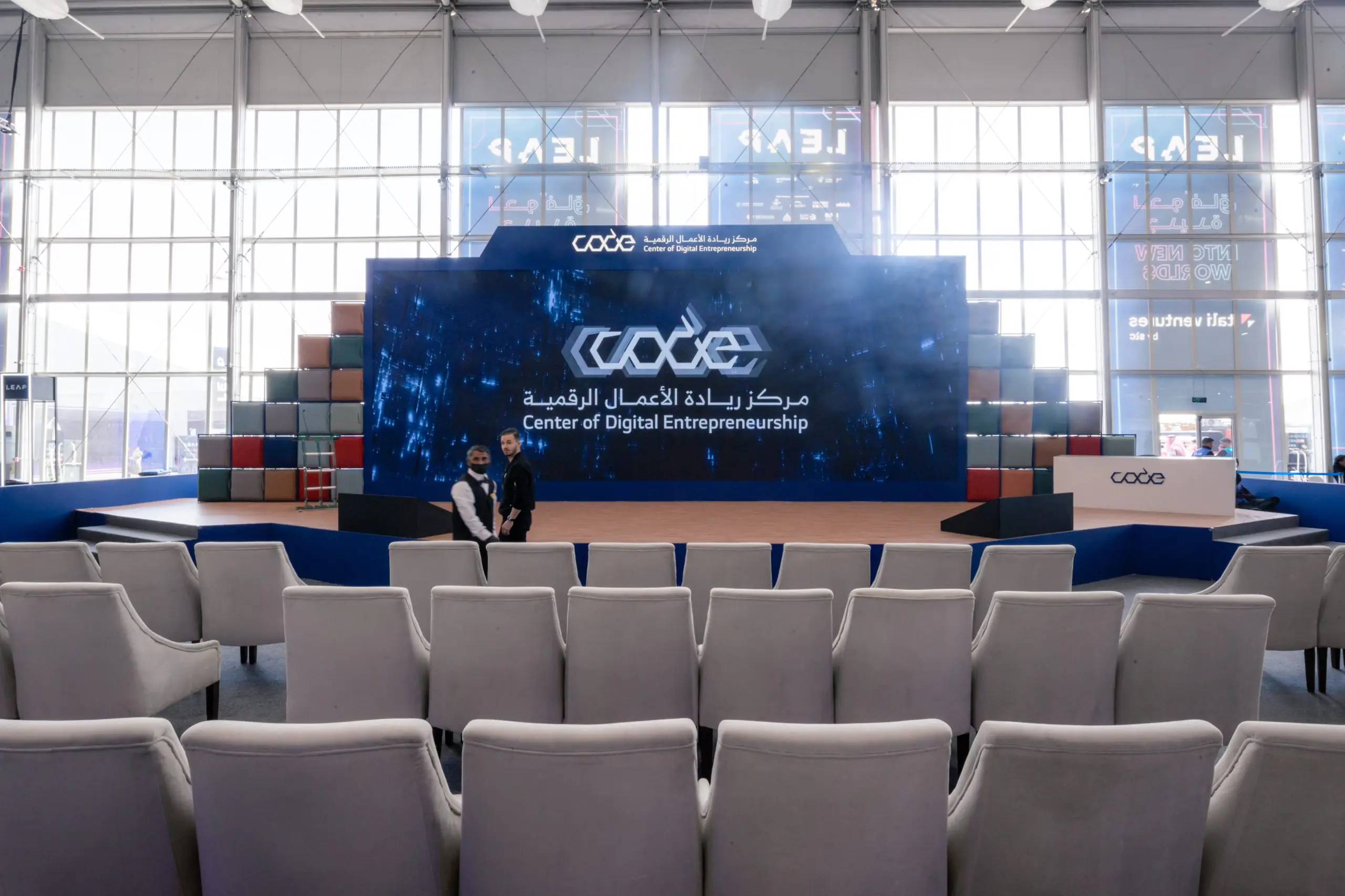 CODE stage setup at Leap event, with a large screen displaying 'Center of Digital Entrepreneurship' and seating area in the foreground