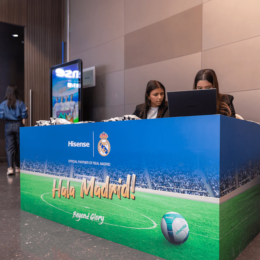 Registration desk with Hisense Real Madrid branding at the Hisense Real Madrid event