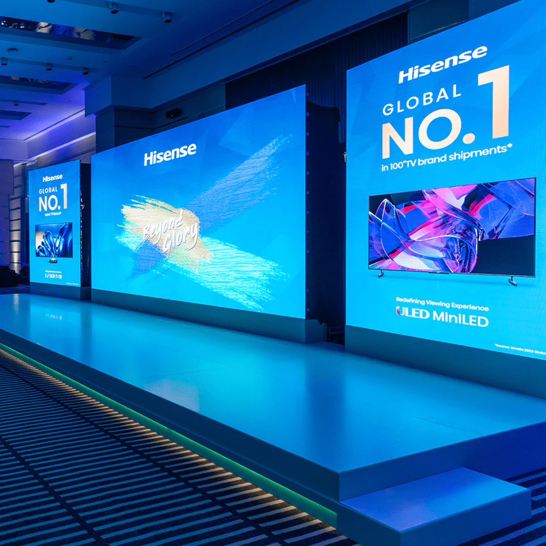 Stage setup with Hisense Global No. 1 branding and ULED Mini-LED display, highlighting their success at the Real Madrid event