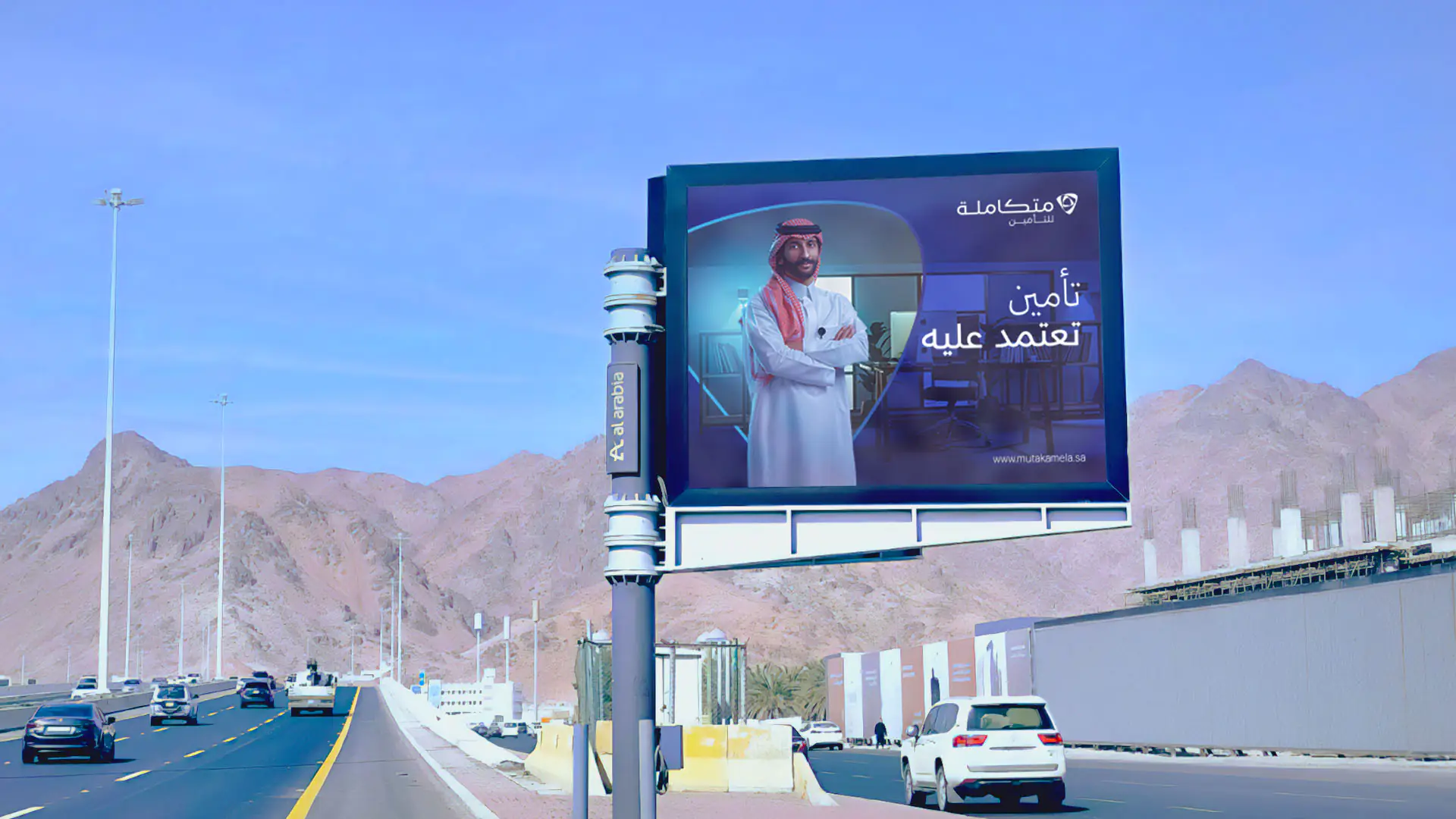 Mutakamela campaign lighting up Madinah at night, emphasizing trust and innovation in insurance services.