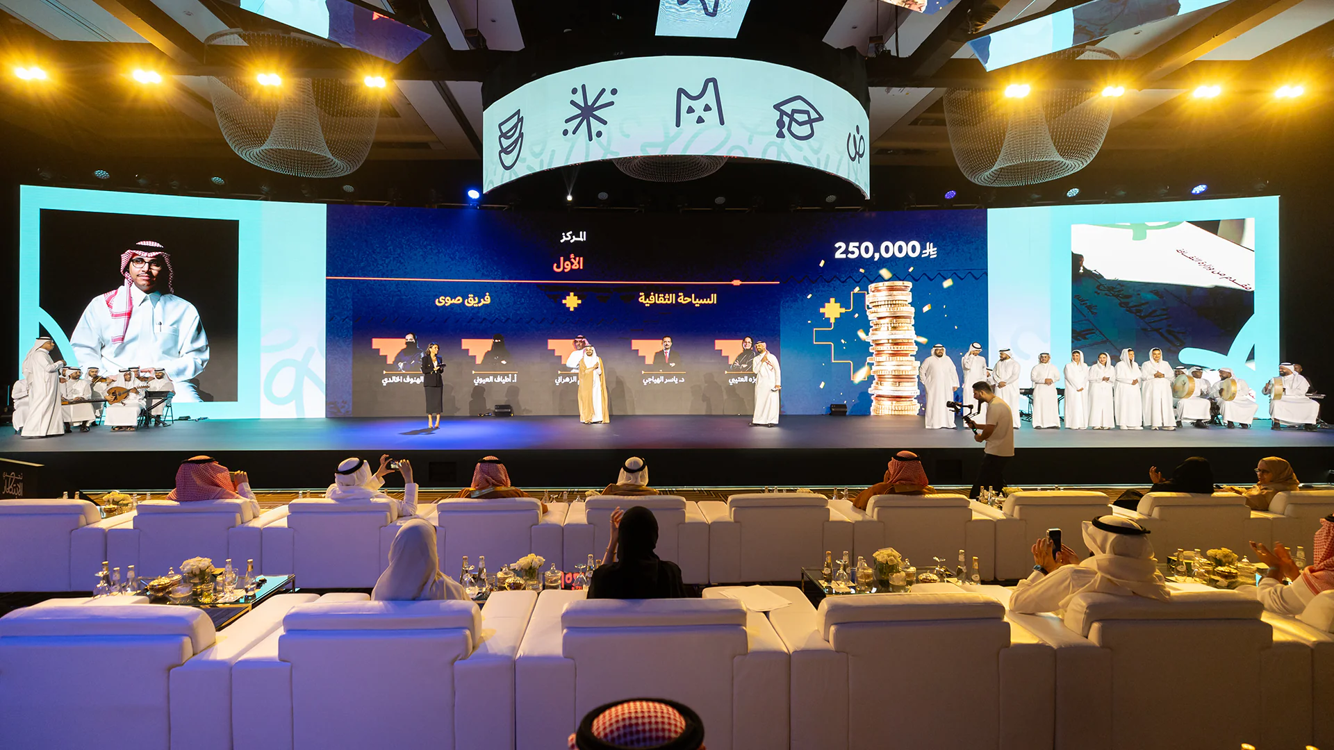 Awards ceremony honoring the winning team with visuals of prize value and cultural theme.
