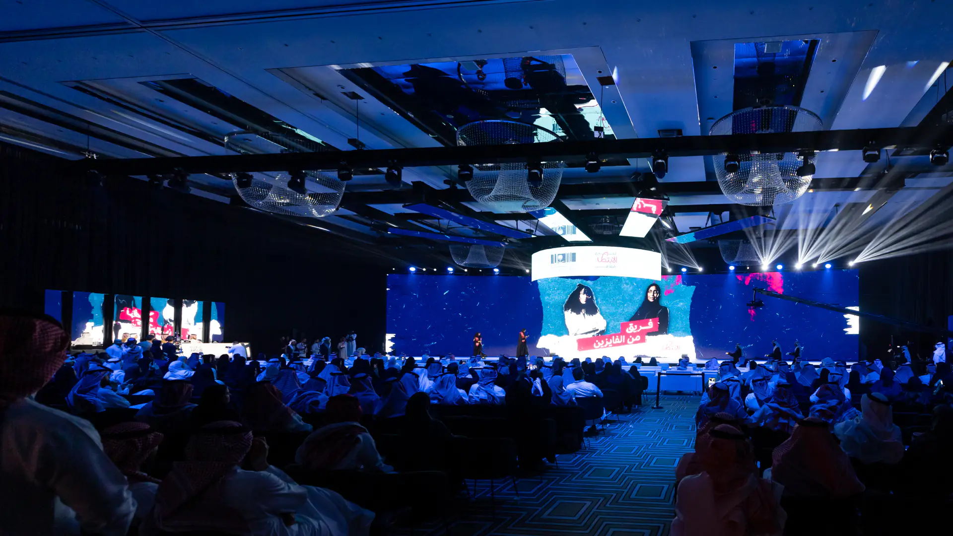 Main stage with a blue theme, seating setup, and pre-event lighting for Policython opening ceremony.