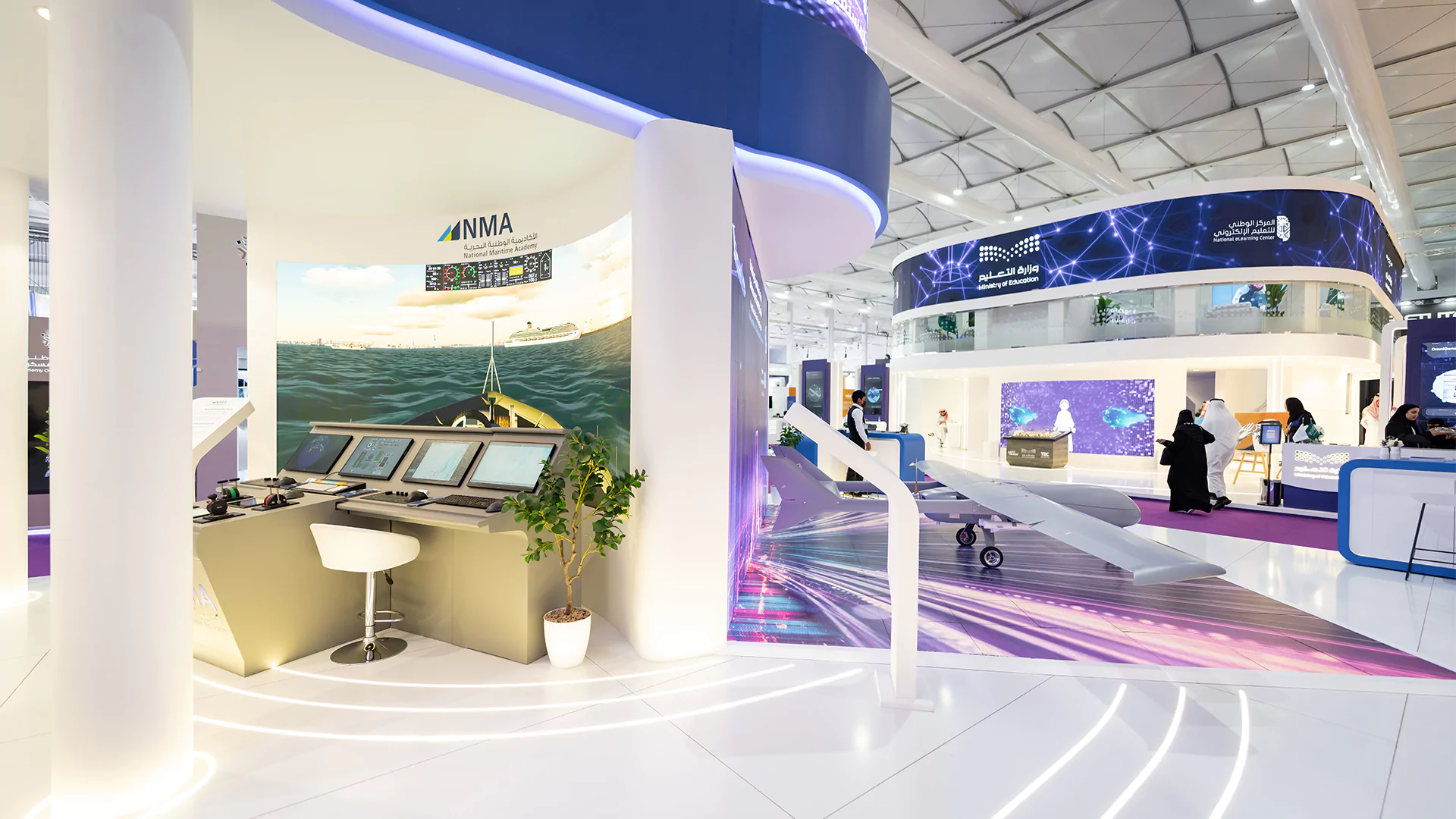 Booth interior view showing navigation simulator zone beside the drone floor LED feature, College of Excellence, WDS 2026.