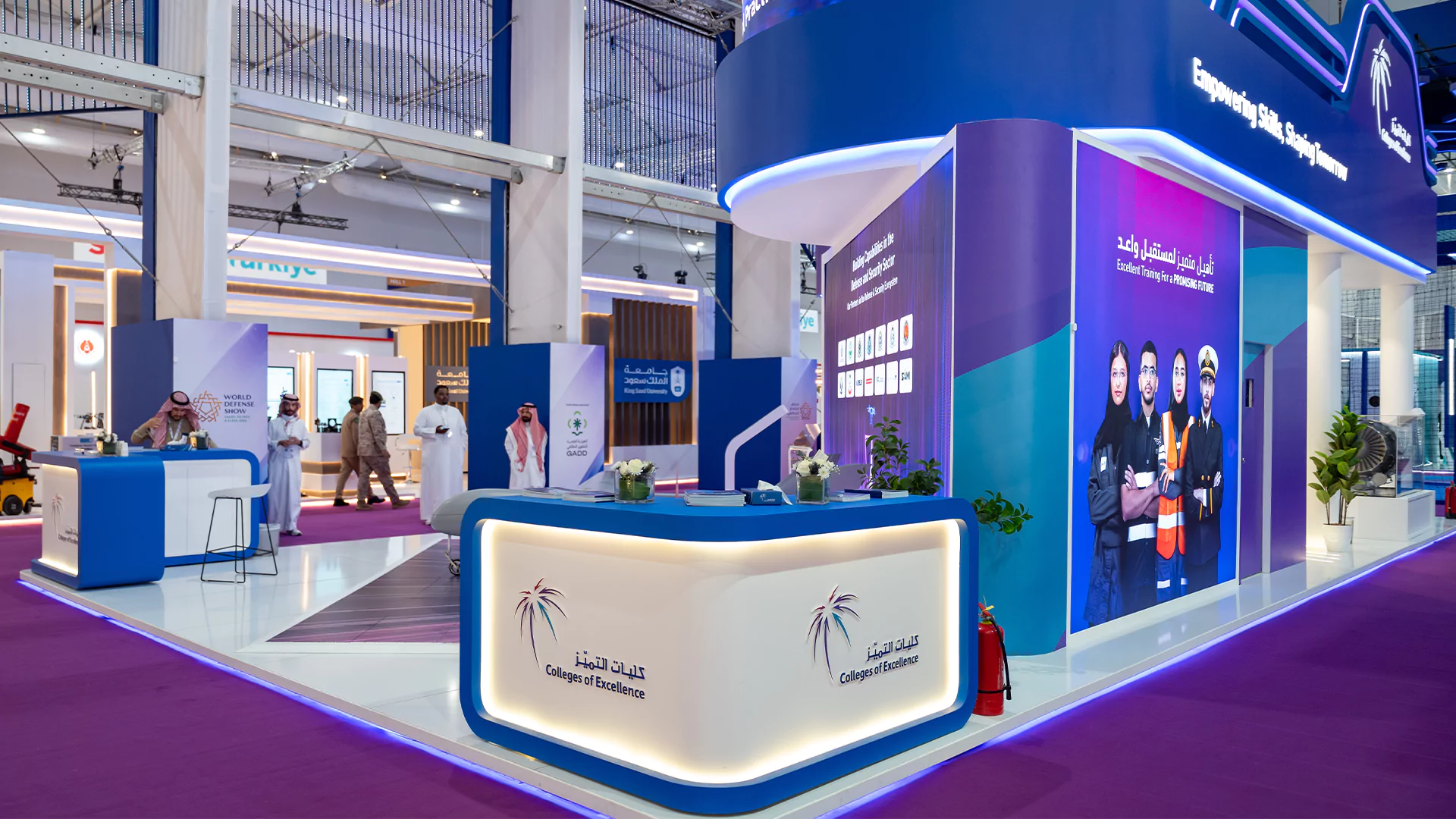 Side view of the booth entrance with illuminated reception counter and branding wall, College of Excellence, WDS 2026.