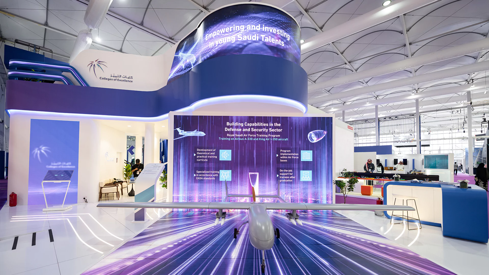 Front drone display aligned with floor LED graphics and main LED wall at College of Excellence booth, WDS 2026.