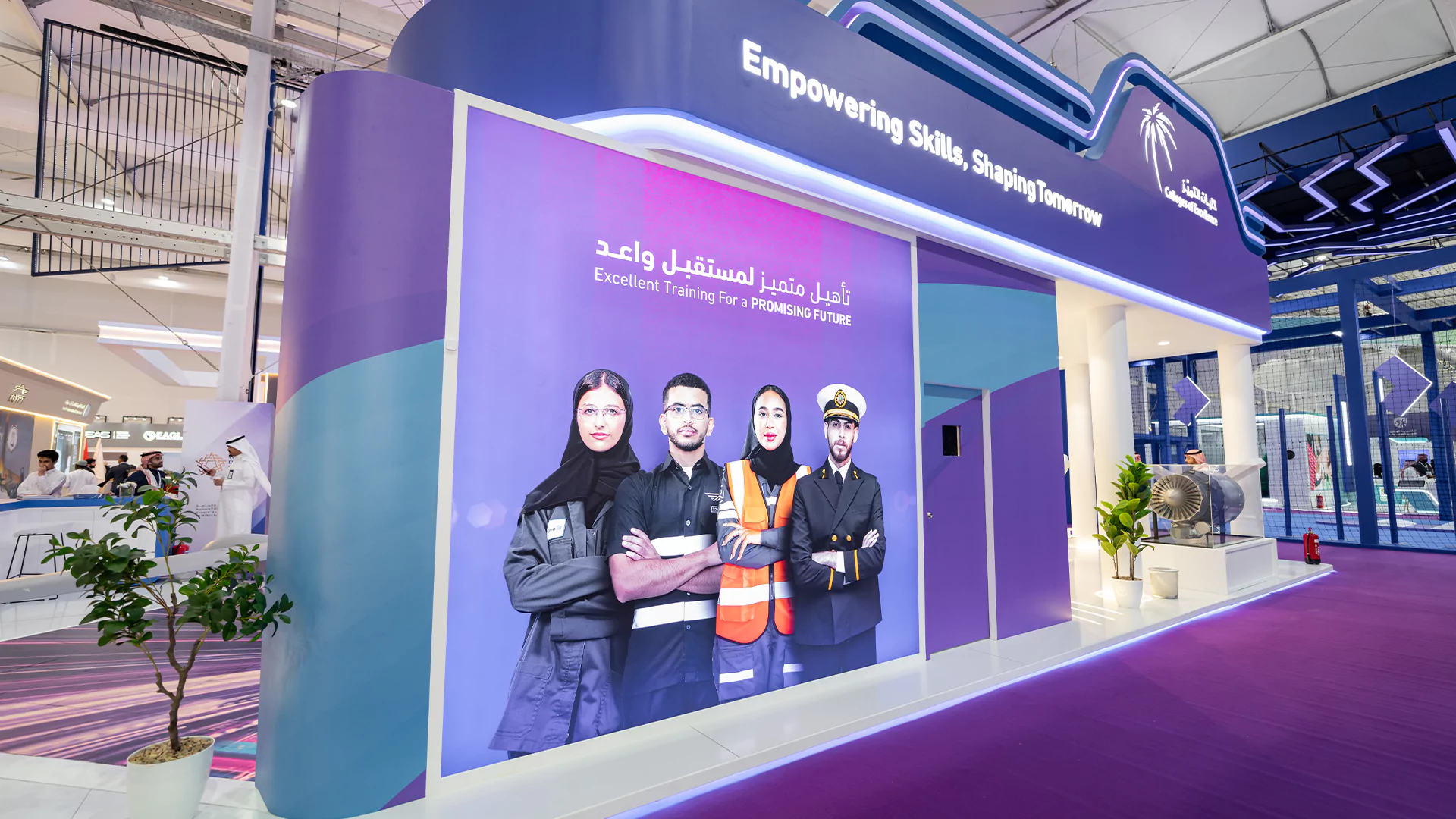 Branding wall featuring program visuals on the booth exterior, College of Excellence double-deck stand, WDS 2026.