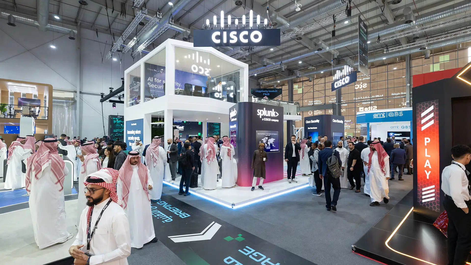 Wide view of Cisco double-deck booth with crowds and partner pod branding at Black Hat 2025.