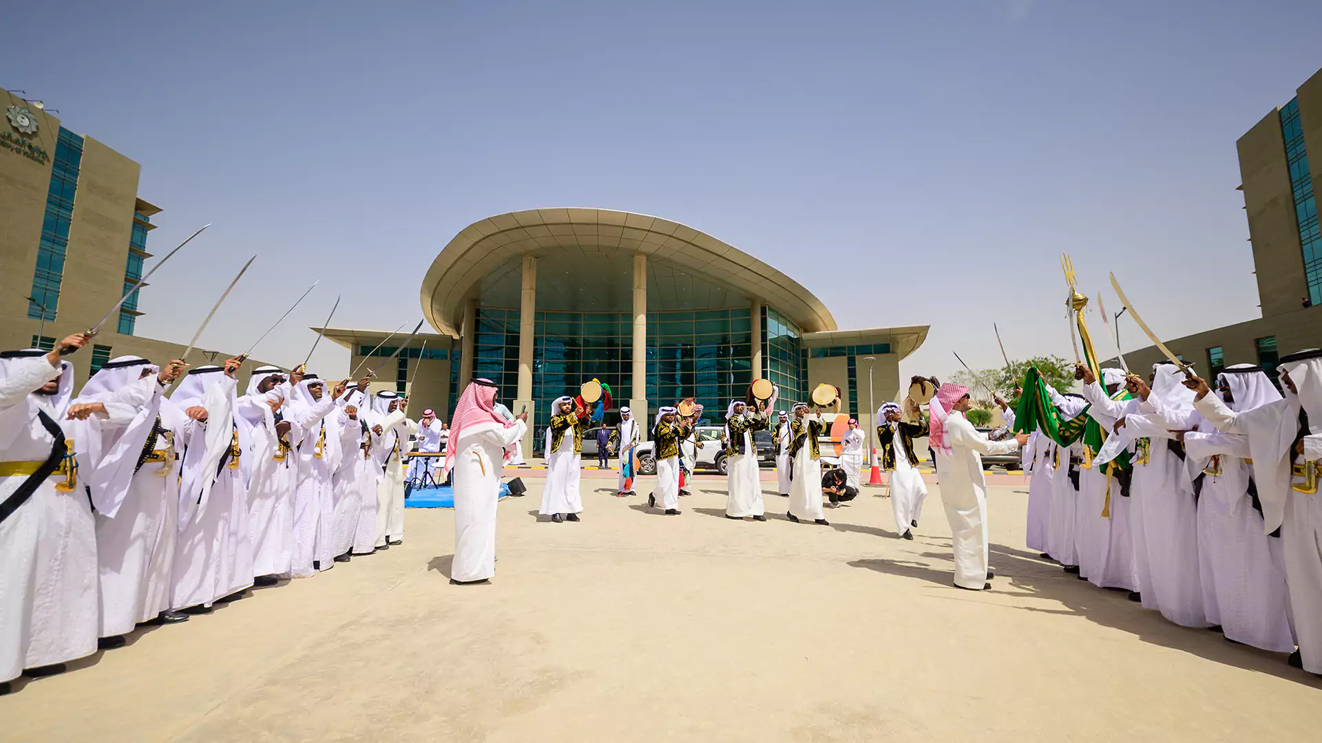 Traditional Ardah dancers performing outside Granada Business building