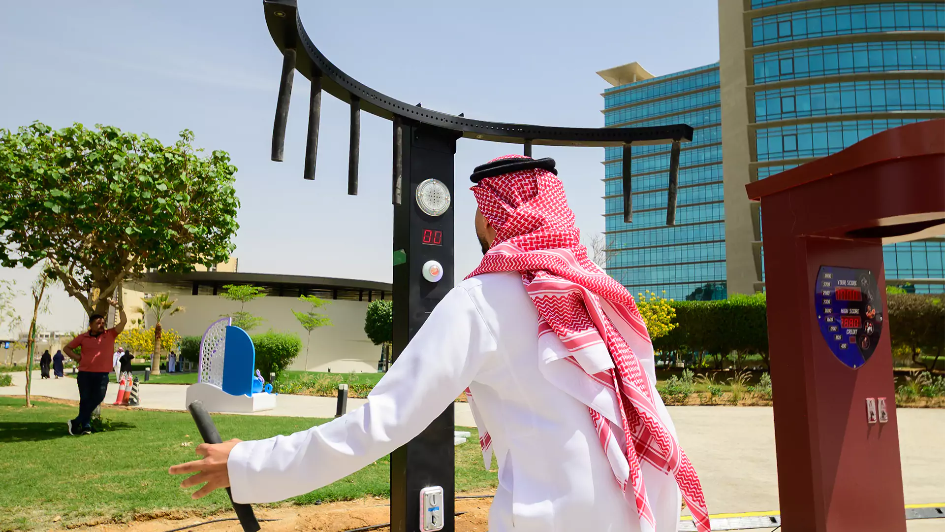Visitor playing strength game at Eid activation area