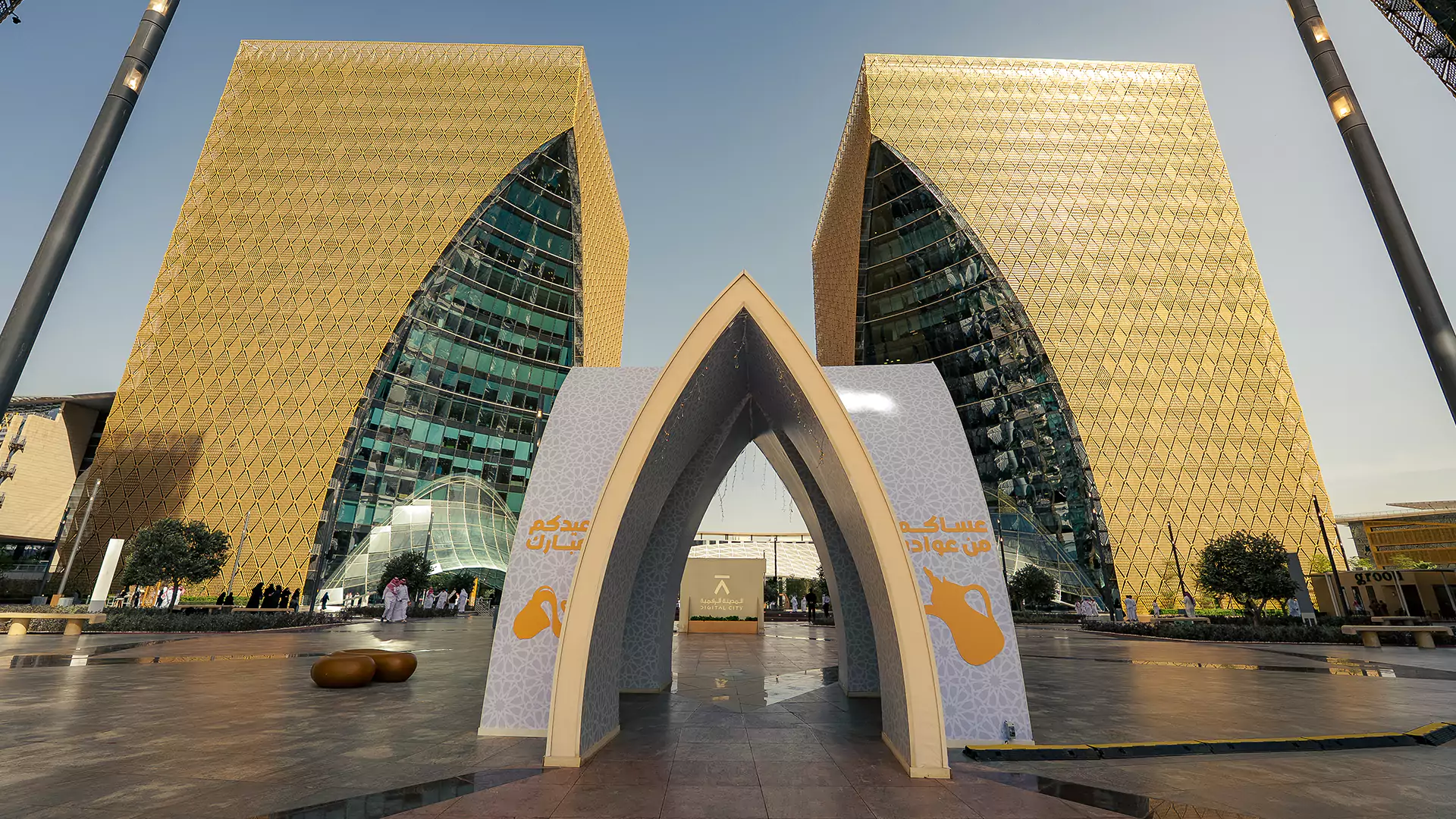 Large Eid gateway installation framed by iconic Digital City towers in Riyadh