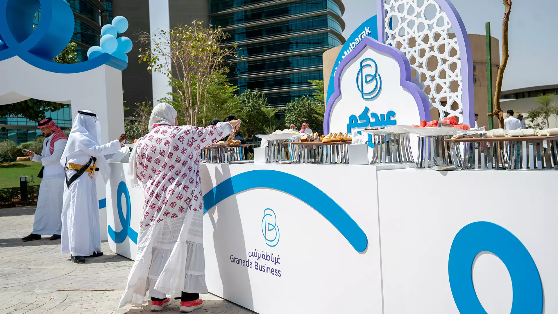 Guests serving food at Granada Business Eid hospitality station