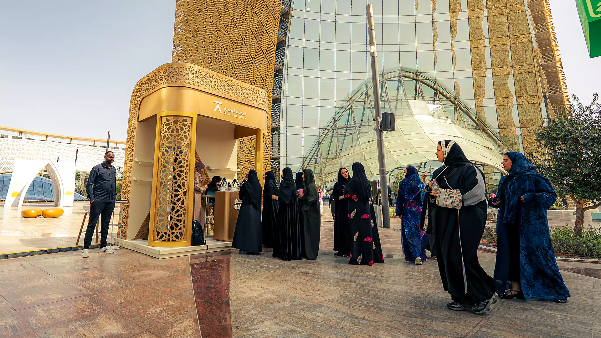 Visitors gathered around activation booth with Arabic coffee and engagement activities